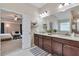 Bathroom featuring double sinks, granite countertops, modern fixtures, and an entrance to the bedroom at 4708 Tiger Blvd, Duluth, GA 30096