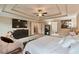 Spacious main bedroom featuring a decorative trey ceiling, large TV, and walk-in closet at 4708 Tiger Blvd, Duluth, GA 30096