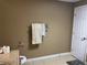 Neutral colored bathroom with a towel rack holding decorative towels next to the commode and linen closet at 1159 Aurora Ct, Atlanta, GA 30338