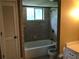 A bathroom with a shower and bathtub and tiled walls and window at 1159 Aurora Ct, Atlanta, GA 30338