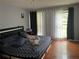 Bedroom with hardwood floors, stylish curtains, and a comfortable bed at 1159 Aurora Ct, Atlanta, GA 30338