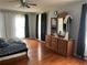 Sunlit bedroom featuring hardwood floors and a dresser with mirror at 1159 Aurora Ct, Atlanta, GA 30338