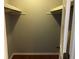 A walk in closet with shelves and hardwood floor at 1159 Aurora Ct, Atlanta, GA 30338