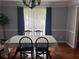 Dining room with hardwood floors, crown molding, and a large table set for a formal dinner at 1159 Aurora Ct, Atlanta, GA 30338
