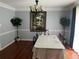 Formal dining room featuring hardwood floors, elegant chandelier, and large decorative artwork at 1159 Aurora Ct, Atlanta, GA 30338