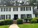 Charming two-story house featuring a brick facade, dark shutters, and a well-maintained front yard at 1159 Aurora Ct, Atlanta, GA 30338