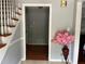 Inviting foyer with staircase, hardwood floors, and a decorative vase of pink flowers at 1159 Aurora Ct, Atlanta, GA 30338