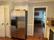 Well-equipped kitchen with stainless steel refrigerator, granite countertops, and hardwood floors at 1159 Aurora Ct, Atlanta, GA 30338