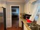 Kitchen featuring a stainless steel refrigerator, hardwood floors, and a view to the dining room at 1159 Aurora Ct, Atlanta, GA 30338