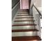A staircase with wood treads and white risers and handrail at 1159 Aurora Ct, Atlanta, GA 30338