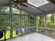 Cozy sunroom featuring tiled flooring and large windows with views of lush greenery at 1159 Aurora Ct, Atlanta, GA 30338