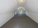 Spacious bonus room with carpeted floor and arched window at 132 Lynnview Ct, Mcdonough, GA 30252
