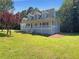 Charming home with a spacious front porch, well-manicured lawn, and inviting curb appeal at 132 Lynnview Ct, Mcdonough, GA 30252