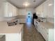 Well-lit kitchen with all white cabinetry, modern appliances, and an eat-in breakfast nook at 132 Lynnview Ct, Mcdonough, GA 30252