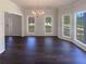 Open living area with hardwood floors, large windows, and abundant natural light at 132 Lynnview Ct, Mcdonough, GA 30252
