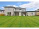 Expansive backyard with covered patio, outdoor kitchen, and lush green lawn, perfect for entertaining at 2751 Camp Branch Rd, Buford, GA 30519