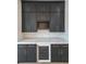 A modern bar area featuring dark cabinetry, a wine rack, marble countertops, and a beverage cooler at 2751 Camp Branch Rd, Buford, GA 30519