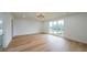 Bright bedroom with large windows offering an outdoor view and a modern light fixture at 2751 Camp Branch Rd, Buford, GA 30519