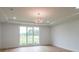 Bright bedroom with hardwood floors, recessed lighting, and sliding glass door to backyard at 2751 Camp Branch Rd, Buford, GA 30519