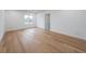 Bright, spacious bedroom with light hardwood floors, base molding, and a large window at 2751 Camp Branch Rd, Buford, GA 30519