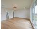 Spacious bedroom featuring light hardwood floors, a modern light fixture, and a walk-in closet at 2751 Camp Branch Rd, Buford, GA 30519