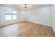 A spacious bedroom with hardwood floors and a modern chandelier-style light fixture at 2751 Camp Branch Rd, Buford, GA 30519