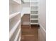 Neat organized closet with white shelves and hardwood floors at 2751 Camp Branch Rd, Buford, GA 30519
