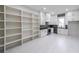 Open white kitchen design featuring extensive shelving, sleek countertops, and modern appliances at 2751 Camp Branch Rd, Buford, GA 30519