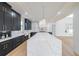 Contemporary kitchen with a large marble island, sleek cabinets, and modern lighting at 2751 Camp Branch Rd, Buford, GA 30519