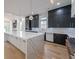 Beautiful kitchen with a large island, black cabinets, stainless steel appliances, and hardwood floors at 2751 Camp Branch Rd, Buford, GA 30519