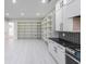 A modern kitchen showcasing white cabinetry, extensive shelving, dark countertops, and modern appliances at 2751 Camp Branch Rd, Buford, GA 30519