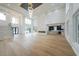 Bright, open-concept living room with high ceilings, fireplace, and hardwood floors at 2751 Camp Branch Rd, Buford, GA 30519