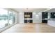 Spacious living room with large windows, hardwood floors, built-in bar, and stylish chandelier at 2751 Camp Branch Rd, Buford, GA 30519