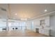 Open-concept living room with hardwood floors, mini bar, modern fireplace, and elegant chandelier at 2751 Camp Branch Rd, Buford, GA 30519