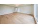 A spacious living room with hardwood floors, large windows, tray ceiling, and modern design elements at 2751 Camp Branch Rd, Buford, GA 30519