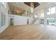 Grand living area with high ceilings, elegant chandeliers, and open staircase at 2751 Camp Branch Rd, Buford, GA 30519