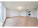 A bright living room featuring hardwood floors, large windows, tray ceilings, and a decorative light fixture at 2751 Camp Branch Rd, Buford, GA 30519