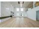 Spacious living room with large windows, modern fireplace, and hardwood floors at 2751 Camp Branch Rd, Buford, GA 30519