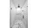 Beautiful marble tiled shower with glass door and modern fixtures at 2751 Camp Branch Rd, Buford, GA 30519