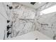 Elegant walk-in shower with marble tile, a rainfall showerhead, and a built-in niche at 2751 Camp Branch Rd, Buford, GA 30519
