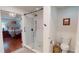 Bright bathroom featuring a glass-enclosed shower and adjacent bedroom with hardwood floors at 2884 Overwood Ln, Snellville, GA 30078