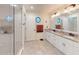 Bright bathroom features a double vanity with granite countertops and a glass enclosed shower at 2884 Overwood Ln, Snellville, GA 30078