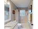 Bright bathroom with granite counters, white tile, and coordinated fixtures at 2884 Overwood Ln, Snellville, GA 30078