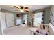 Cozy bedroom with a ceiling fan, two windows, neutral carpet, and playful decor at 2884 Overwood Ln, Snellville, GA 30078