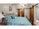 Bedroom with barn doors and a bed with blue patterned bedding at 2884 Overwood Ln, Snellville, GA 30078