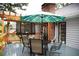 Relaxing outdoor deck with an umbrella table, chairs, and brick chimney at 2884 Overwood Ln, Snellville, GA 30078