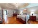 Spacious bedroom features a tray ceiling, hardwood floors, and a chandelier at 2884 Overwood Ln, Snellville, GA 30078