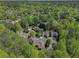An aerial view of a home in a vibrant neighborhood surrounded by lush greenery at 1935 Northbrooke Ln, Dunwoody, GA 30338