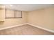 Basement with carpeted floor, neutral walls, and a large window for natural light at 1935 Northbrooke Ln, Dunwoody, GA 30338