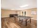 Spacious basement with modern flooring, ping pong table, and walkout to the backyard at 1935 Northbrooke Ln, Dunwoody, GA 30338